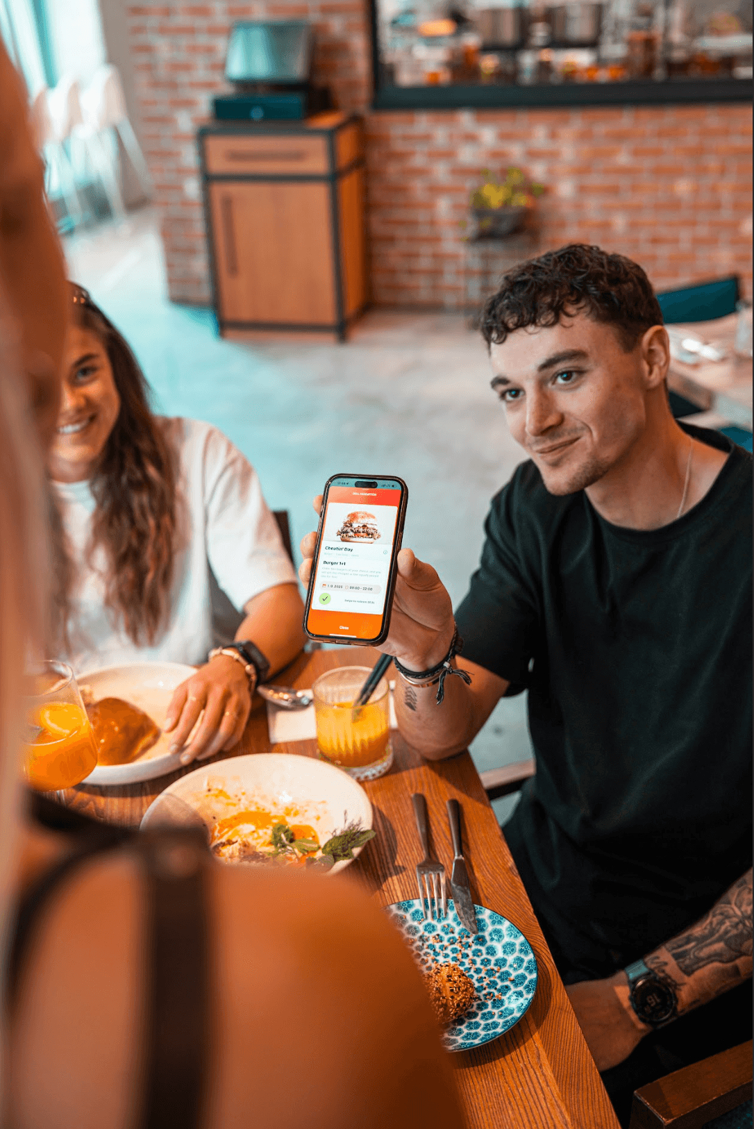 Happy guests at a table with the TasteTown app